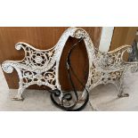 A pair of cast iron bench ends decorated with flowers and leaves together with a pair of scrolling