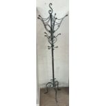 A modern cast iron hat and coat stand on three legs
