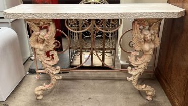 A cast iron and reconstituted stone console table with a rectangular top with cut corners,