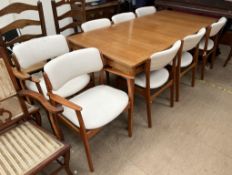 A mid 20th century Danish teak extending dining table and eight chairs possibly by Erik Buch,