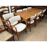 A mid 20th century Danish teak extending dining table and eight chairs possibly by Erik Buch,