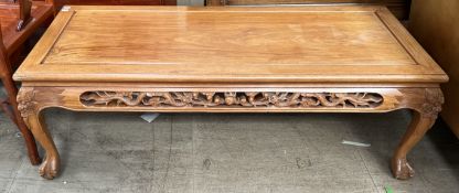 A Chinese hardwood coffee table with a rectangular top and dragon carved border on cabriole legs