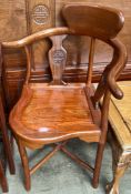 A Chinese hardwood corner elbow chair with vase shaped splats on tapering legs