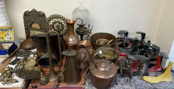 A collection of shoe lasts together with a copper kettle, copper jugs, oil lamp, brass wares,