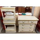 A modern cream and yellow painted chest with two short and three long drawers together with a pair