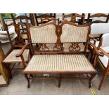 An Edwardian mahogany part salon suite comprising a two seater settee,