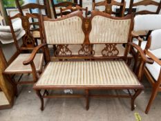 An Edwardian mahogany part salon suite comprising a two seater settee,