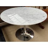 A marble topped dining table of circular form on a chrome base of tulip form,