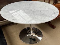 A marble topped dining table of circular form on a chrome base of tulip form,
