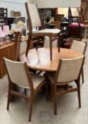 A mid 20th century teak dining suite including an extending dining table,