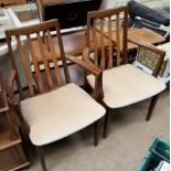 A pair of G-Plan teak elbow dining chairs