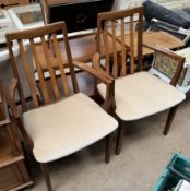 A pair of G-Plan teak elbow dining chairs