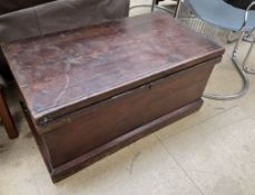 A pine coffer with a rectangular hinged top and carrying handles