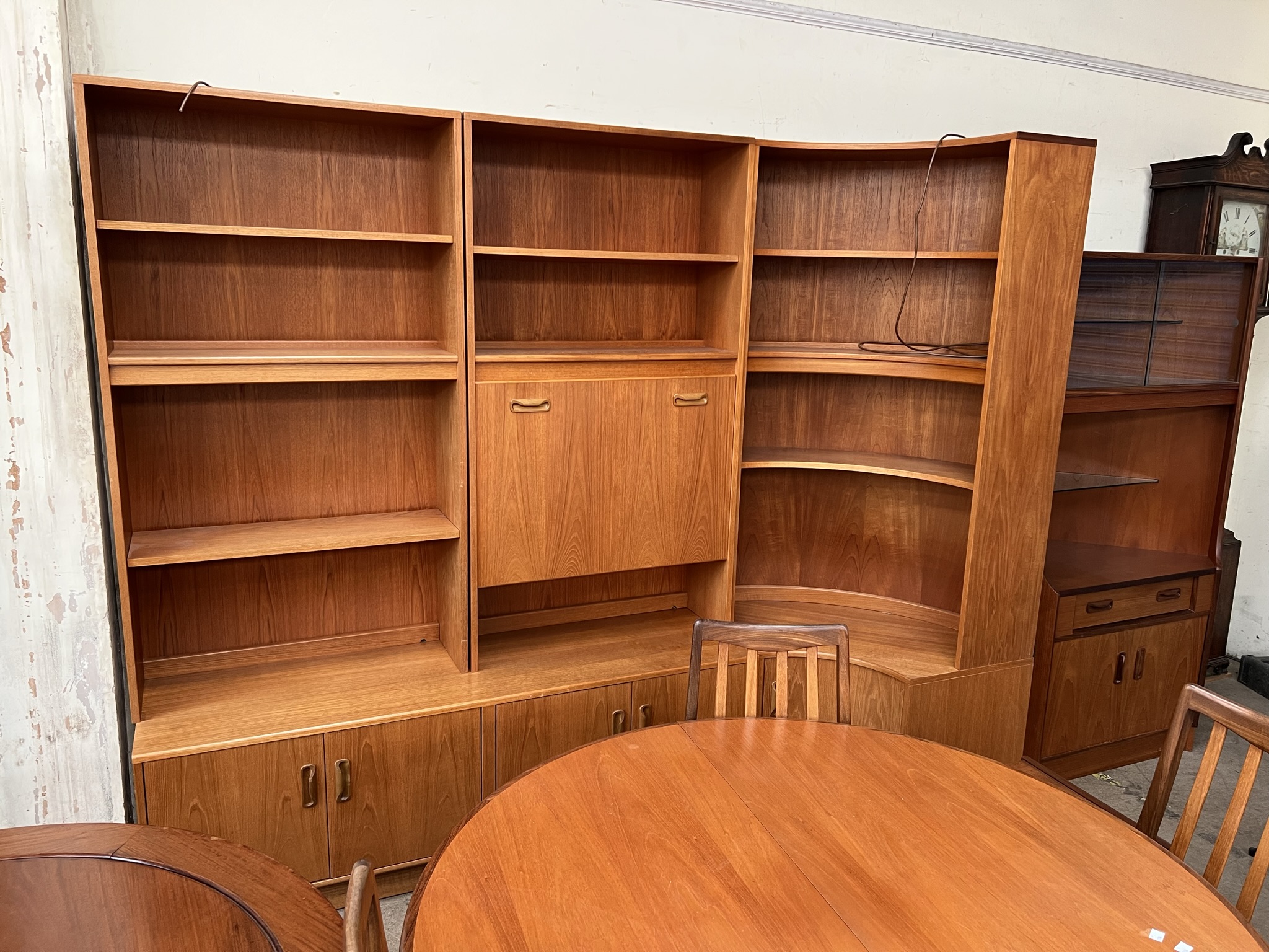 A G-Plan DE Gomme Ltd teak wall unit comprising a central drinks cabinet,