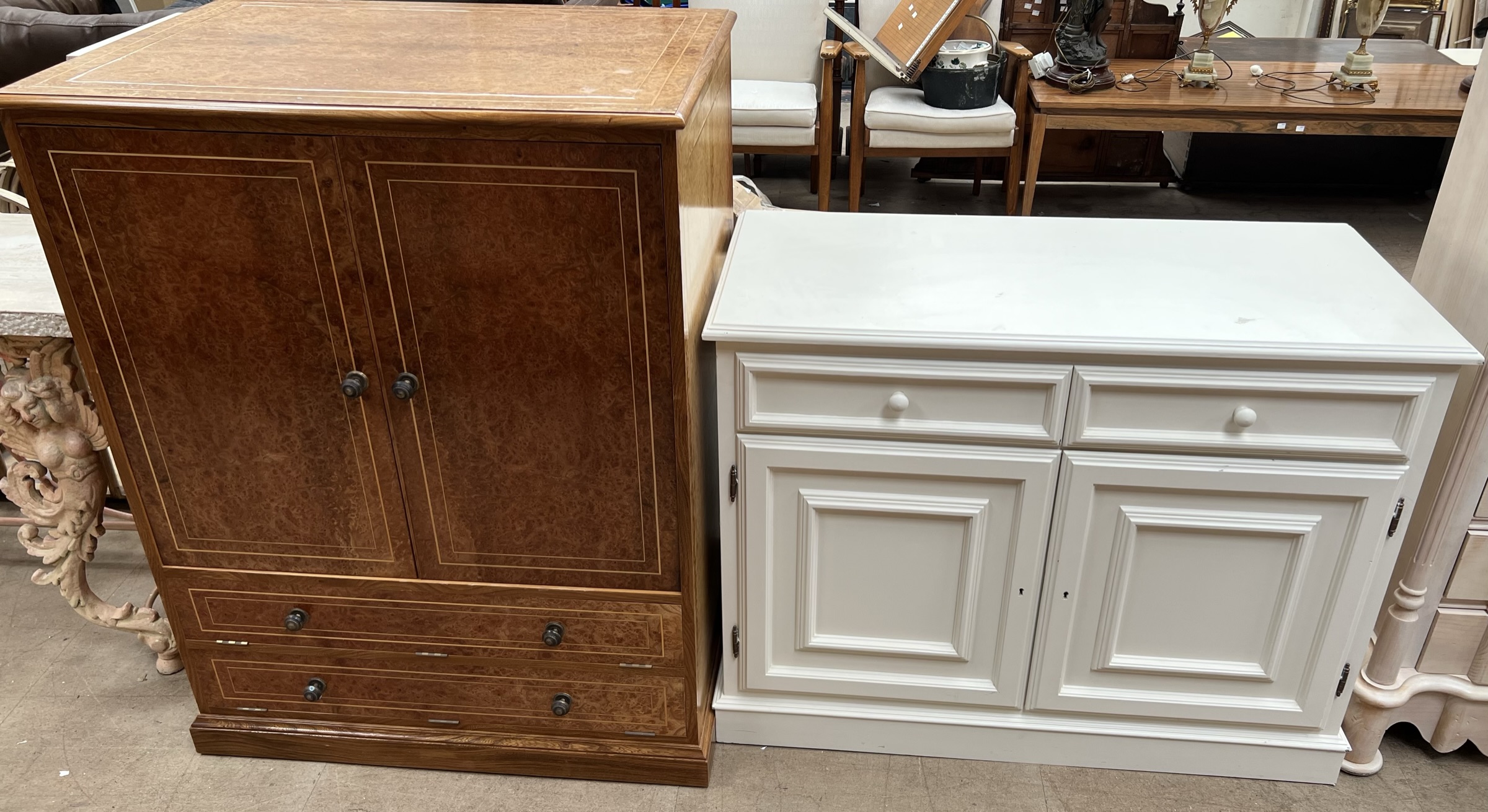 A cream side cabinet with two drawers and two cupboards on a plinth base together with a burr