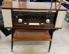 A Phillips Reverbeo radio with a gloss cabinet on a shelved base