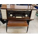 A Phillips Reverbeo radio with a gloss cabinet on a shelved base