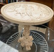 A simulated ivory wine table moulded with figures in a carriage,