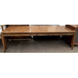 A mid 20th century coffee table on square tapering legs,