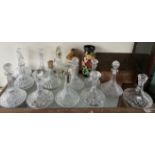 A copper Slippers box together with a collection of crystal glass ships decanters, other decanters,