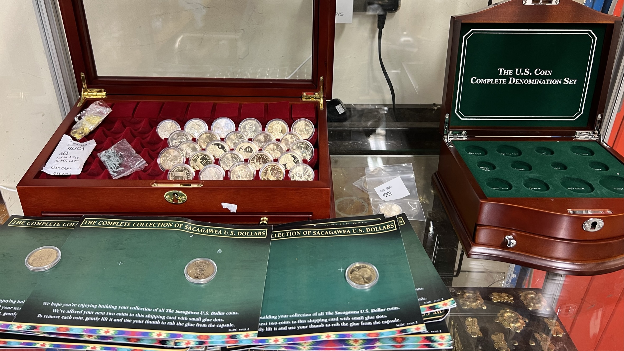 Two coin cases together with American gilt coin, and Scagawea U.S.