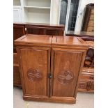 A Chinese hardwood bar, with a foldover top and two hinged doors with a fitted interior,