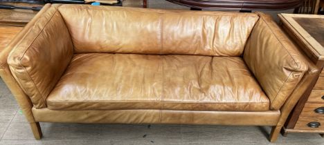A John Lewis brown leather two seater settee with fixed cushions on square tapering legs