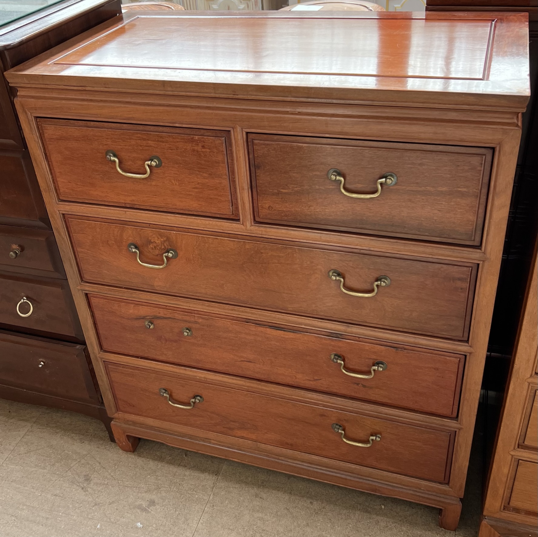 A Chinese hardwood chest with a rectangular top above two short and three long graduated drawers on
