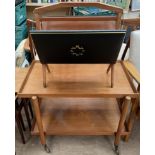 A mid 20th century teak tray top tea trolley together with a folding magazine rack