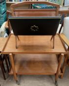 A mid 20th century teak tray top tea trolley together with a folding magazine rack