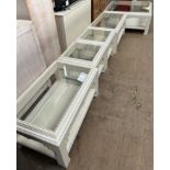 A set of five cream and blue painted glass topped coffee tables of varying sizes