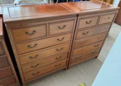 A pair of Chinese hardwood chests with a rectangular top above two short and four long drawers on