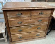 An Edwardian chest with a rectangular moulded top above two short and three long drawers on a