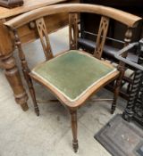 An Edwardian corner chair with pad upholstered seat on turned legs