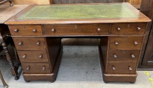 A Victorian oak pedestal desk, with a rectangular leather inset top and a central drawer,