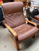 A 20th century upholstered arm chair with brown leather upholstery CONDITION REPORT: