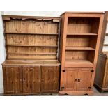 A modern pine dresser, the moulded cornice above three shelves,