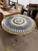 A conservatory table of circular form with a glazed top