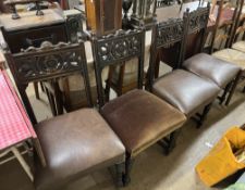 A set of four carved oak dining chairs,