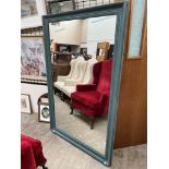 A large painted wall mirror of rectangular form,