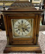 A 20th century German walnut cased mantle clock of architectural form with a silvered dial and 14