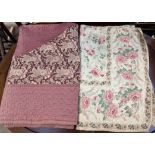 A floral decorated quilt together with another floral decorated quilt