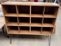 A 1954 Lord Roberts Workshops bookcase with twelve compartments on metal hoop legs,