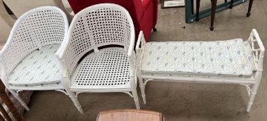 A pair of cream painted faux bamboo elbow chairs and a matching stool