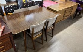 A mid 20th century teak dining suite including a table,
