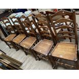A set of five 18th century style ladder back dining chairs with solid seats on turned legs