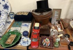 A top hat in a leather case together with a stool, pottery tiles, model cars,