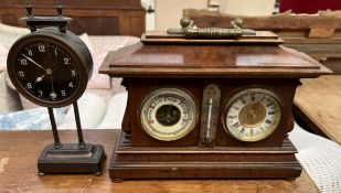 An early 20th century walnut barometer and clock combination with central mercury thermometer