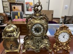 A gilt metal mantle clock together with a brass bracket type clock and another gilt mantle clock