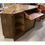 A mid 20th century teak three section corner unit, comprising a secretaire drawer, cupboards,